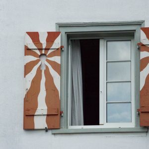 Window shutters with sun pattern