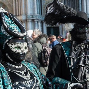 Green and black costumes at Venice Carnival