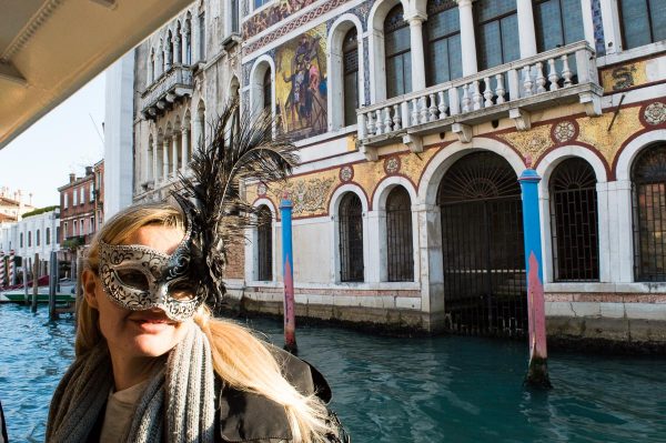 With carnival mask on the Grand Canal
