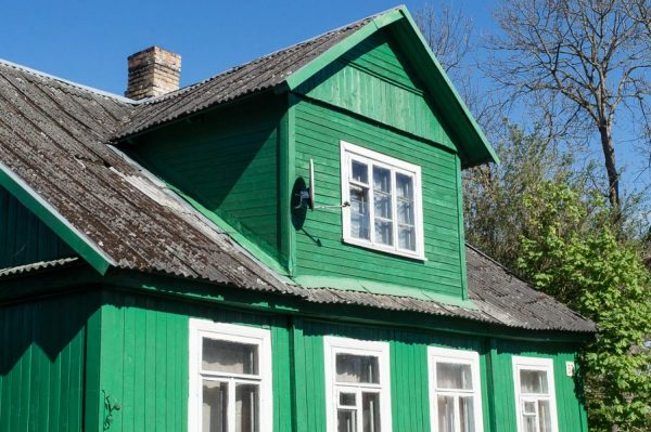 green wooden house in Trakai